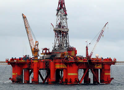 A set of large equipment is drilling oil on the sea.