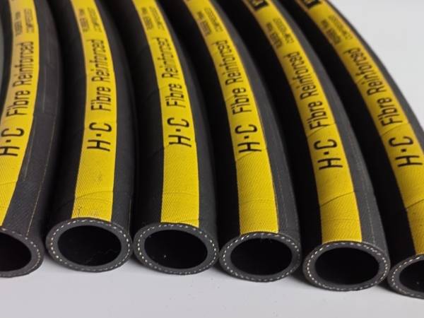 Many yellow and black fiber braided rubber hoses are displayed.