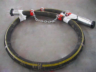 A vibrator hose is on the floor of a workshop.