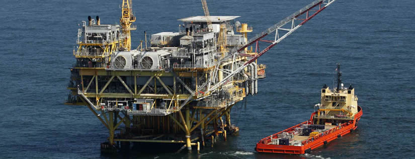 A set of large oil drilling equipment is on the sea.
