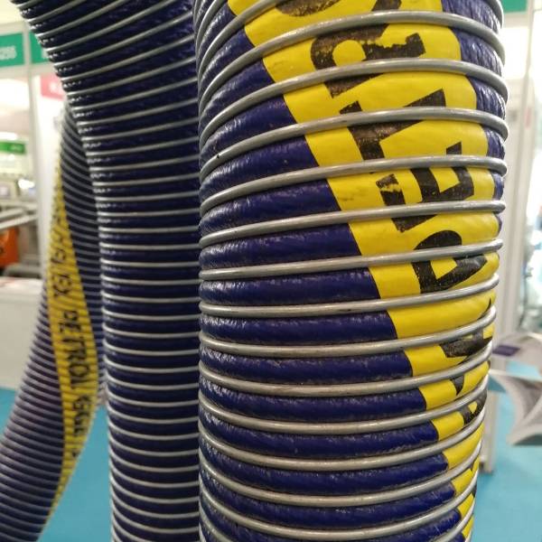 Large diameter suction and discharge composite hoses are displayed.