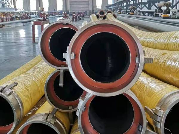 Many large diameter water suction and discharge hoses are displayed.